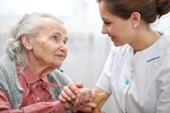 Senior woman with her caregiver at home